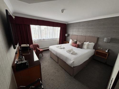 a hotel room with a bed and a desk at The Liner at Liverpool in Liverpool
