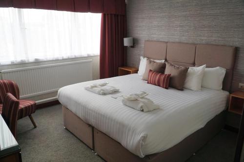 a hotel room with a large bed with towels on it at The Liner at Liverpool in Liverpool