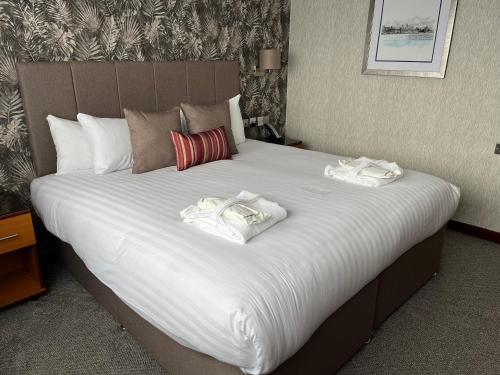 a large bed with two white towels on it at The Liner at Liverpool in Liverpool