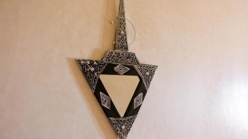a black and white lamp hanging from a wall at Les Jardins d Amizmiz 6 piscines in Marrakech