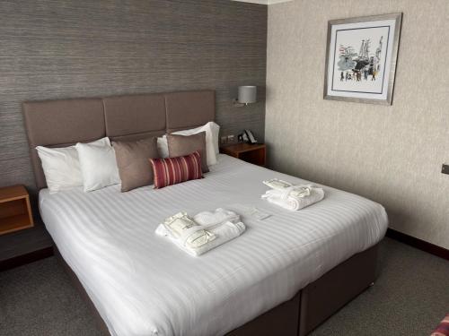 a hotel room with a bed with two towels on it at The Liner at Liverpool in Liverpool