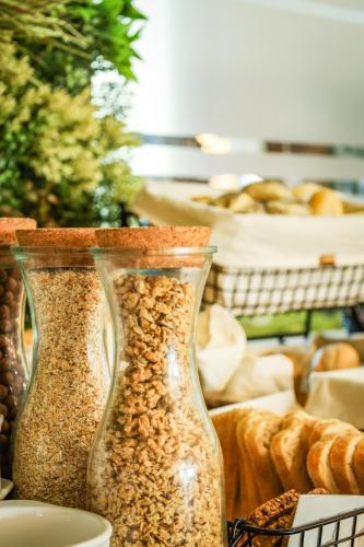 two glass vases filled with food on a table at Omega Hotel in Olsztyn