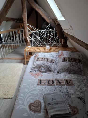 a bedroom with a bed in a attic at La gîte "Ressources" au calme avec jardin et jacuzzi entre Rouen et Le Havre in La Frenaye