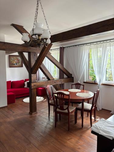 a living room with a table and chairs and a couch at Ostoja Sawica in Szczytno
