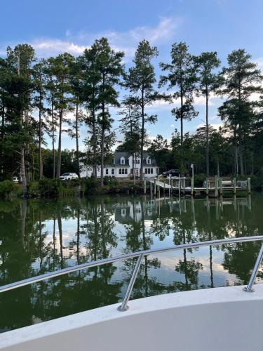 a house on the water with a dock at Serenity in White Stone