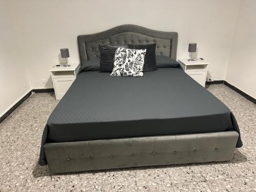 a bedroom with a large bed with two night stands at Pisa center train station in Pisa
