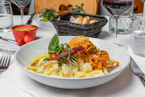 a white bowl of pasta on a table at Sunstar Hotel Klosters in Klosters