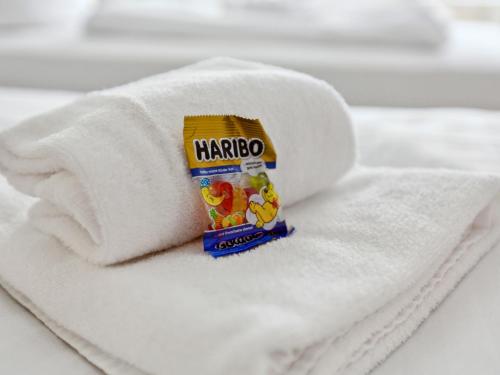 a roll of white towels with a packet of margo at Sali Homes -Business Stay-Rheinische Gemütlichkeit in Kleve
