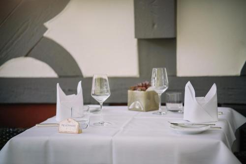 a table with wine glasses and napkins on it at Hotel Restaurant Der Engel, Sasbachwalden in Sasbachwalden