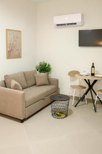 a living room with a couch and a table at ATHENIAN Vibes in Athens
