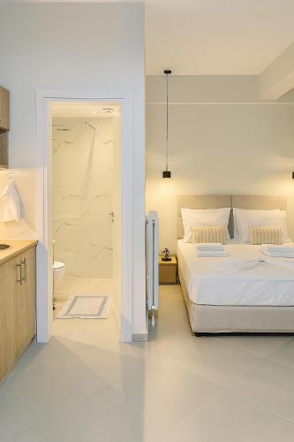 a white bedroom with a bed and a shower at ATHENIAN Vibes in Athens