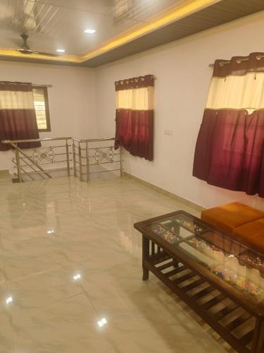 a living room with a couch and a table at Shafi Villa in Neral