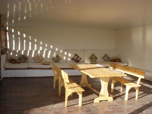 a dining room with a wooden table and chairs at Art Inn in İvanovka