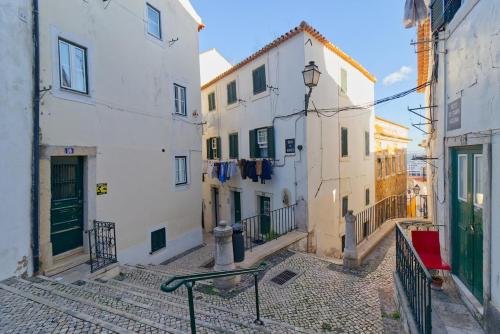 an alley with buildings and a fire hydrant at Cozy studio in Alfama in Lisbon