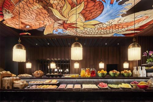 a buffet line with different types of food on display at Avani Avenida Liberdade Lisbon Hotel in Lisbon