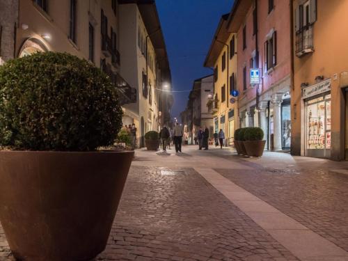 an empty street with people walking down the street at Nonna ITA in Albino