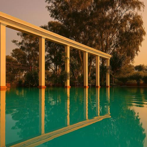 a view of a pool of water with columns at Qila Hotel in Pipalsāna