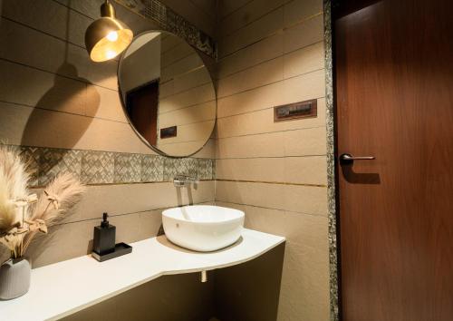 a bathroom with a sink and a mirror at Flare By Blaze in Bhopal