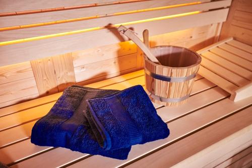a sauna with two mitts and a trash can at Eifelblockhaus in Rieden