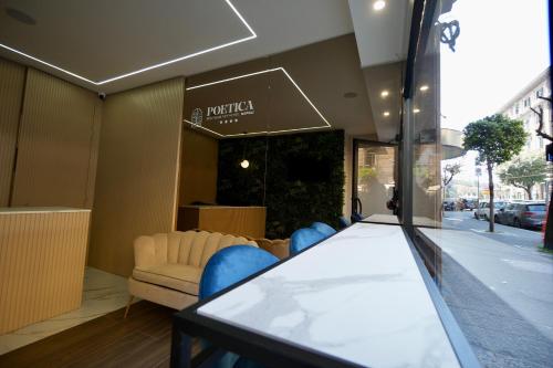 a table and chairs in front of a store at POETICA BOUTIQUE SKY HOTEL in Naples