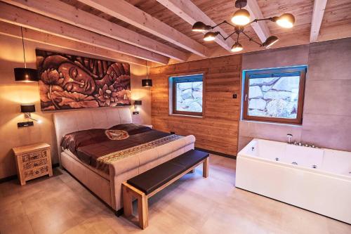 a bedroom with a bed and a bath tub at Wellness Ferienhaus “Lotus I” in Rieden