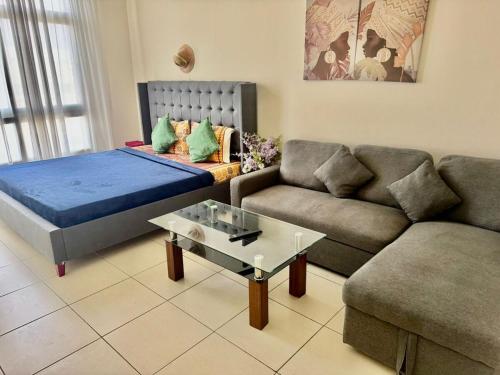 a living room with a bed and a couch at Not far from metro and WTC in Dubai