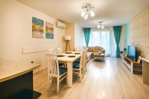 a kitchen and living room with a table and chairs at Apartment RELAX in the city center in Yambol
