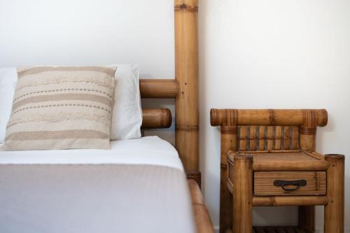 a bed with a pillow and a chair in a room at Love room Aubagne in Aubagne