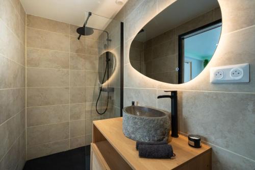 a bathroom with a sink and a mirror at Love room Aubagne in Aubagne