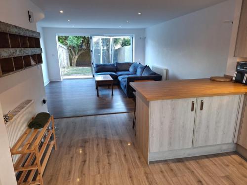 a living room with a couch and a table at Coastal 3BR Garden & Parking in Eastbourne