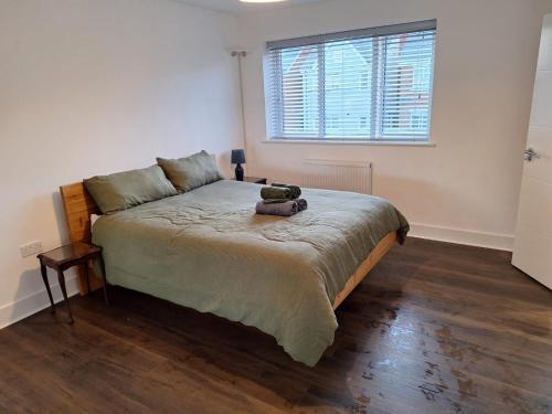 a bedroom with a bed with a teddy bear on it at Coastal 3BR Garden & Parking in Eastbourne