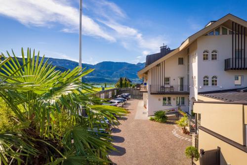 a view from the balcony of a hotel with mountains in the background at Garni Hotel Sonnleitenhof in Caldaro