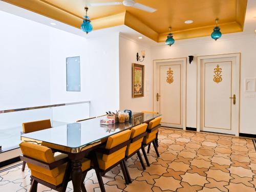 a dining room with a table and chairs at Diwan House in Agra