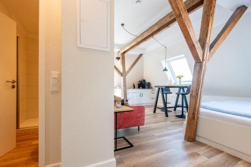 a room with a bed and a kitchen with a table at Steger-Hüs Wohnung 38 in Rantum