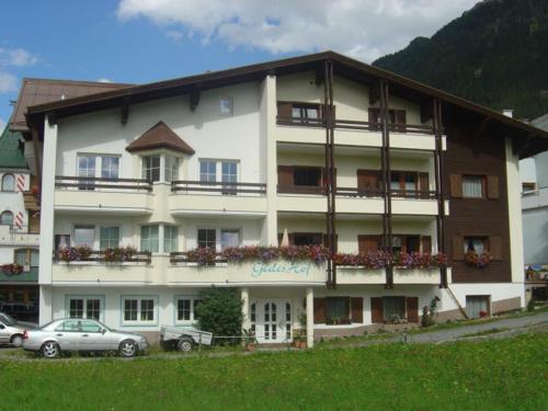 a large building with cars parked in front of it at Gidis Hof in Ischgl