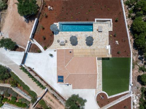 an overhead view of a building with a swimming pool at NEW LUXURY STONE Villa AMENTE in Fiskardho