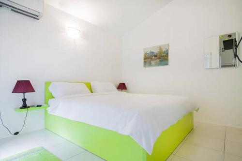 a green and white bed in a white room at Apartments Vanja in Bar