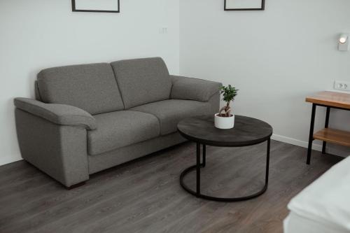 a living room with a couch and a table at Rooms at Podlipje Estate in Tešanovci