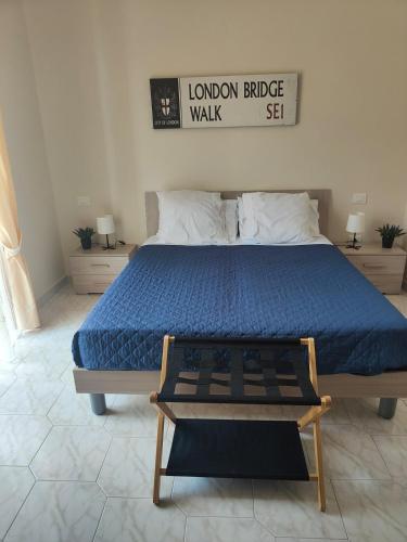 a bedroom with a large bed with a blue comforter at Hyria Intero Appartamento in centro città in Avellino