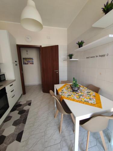 a kitchen with a table with a table cloth on it at Hyria Intero Appartamento in centro città in Avellino