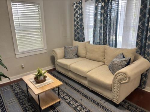 a living room with a couch and a table at Simple 1950s Home Budget Stay , Basic comforts in Tallahassee