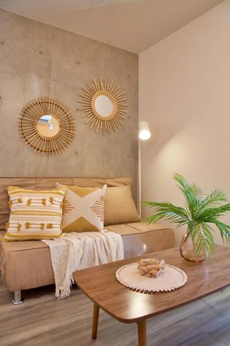 a living room with a couch and two mirrors at TOMALCO INN NAKANO 1 4F Flat 2 Bath 13min to Shinjuku from Honancho in Tokyo