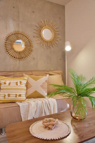 a living room with a couch and two mirrors at TOMALCO INN NAKANO 1 4F Flat 2 Bath 13min to Shinjuku from Honancho in Tokyo