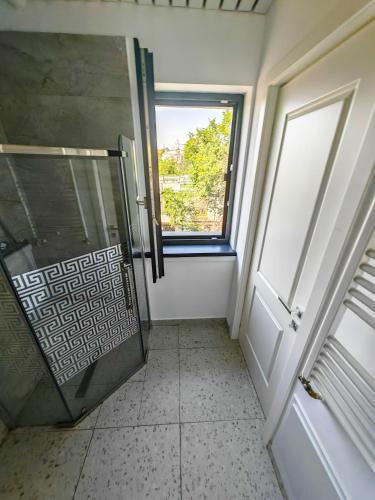 a bathroom with a shower and a window at Little Bucharest downtown apartments Romana in Bucharest