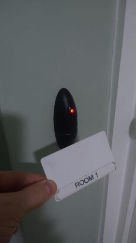 a persons hand holding a red light on a black computer mouse at BS3 Bed and Breakfast in Bristol