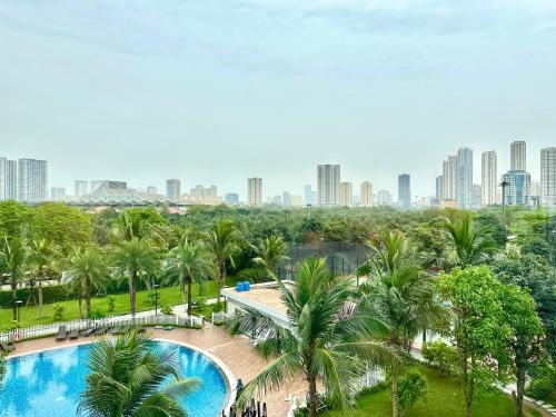 an aerial view of a resort with a pool and palm trees at Luxury Studio With Swimming Pool, Gym And Tennis Courts In City Center in Hanoi