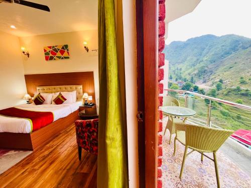 a hotel room with a bed and a balcony at The Kempty Castle, Mussoorie in Mussoorie