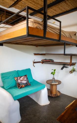 a room with a couch and a bunk bed at Four Trees Jungle Lodge in San Juan del Sur