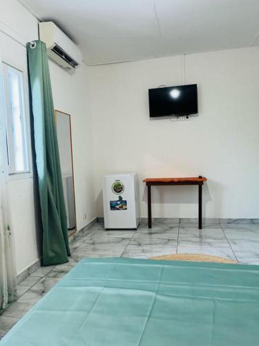 a room with a ping pong table and a television at SteilaDay Hébergement 976 in Pamandzi