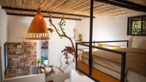 a bedroom with a bed and a lamp in a room at Four Trees Jungle Lodge in San Juan del Sur